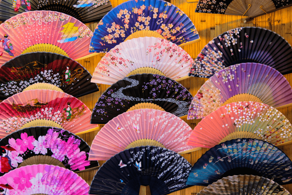 A display of Japanese hand fans in different colors.