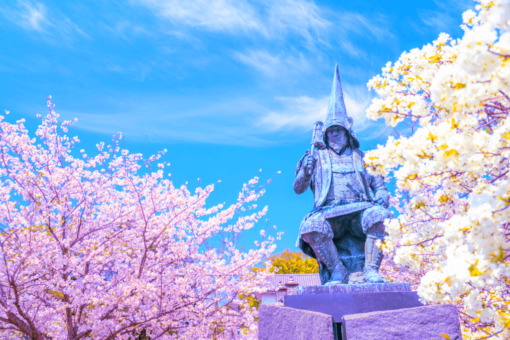 A statue among the cherry blossoms at a park near Kumamoto Castle.