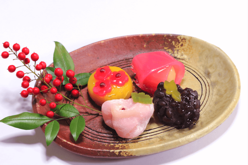 A plate of four, glazed nerikiri sweets.
