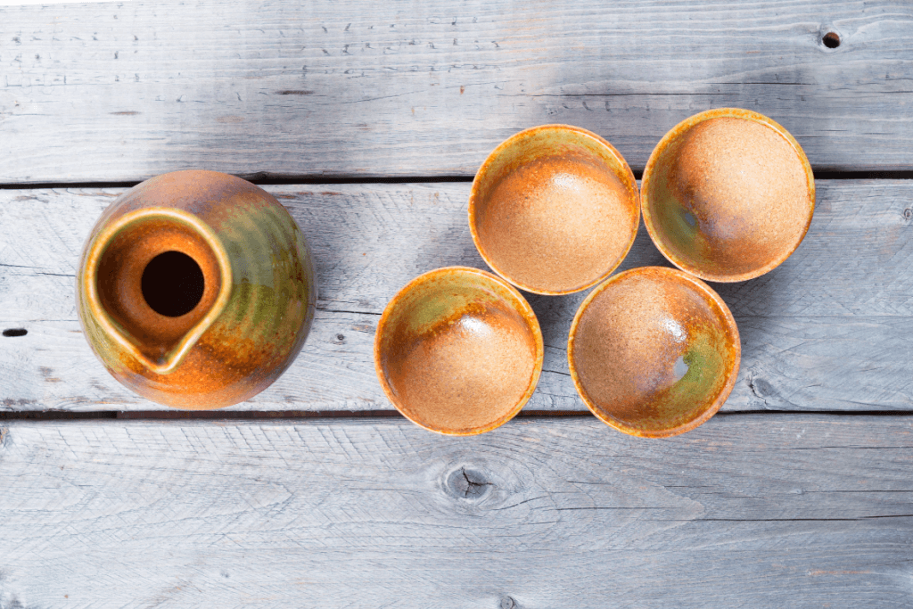 A bunch of brown sake cups.