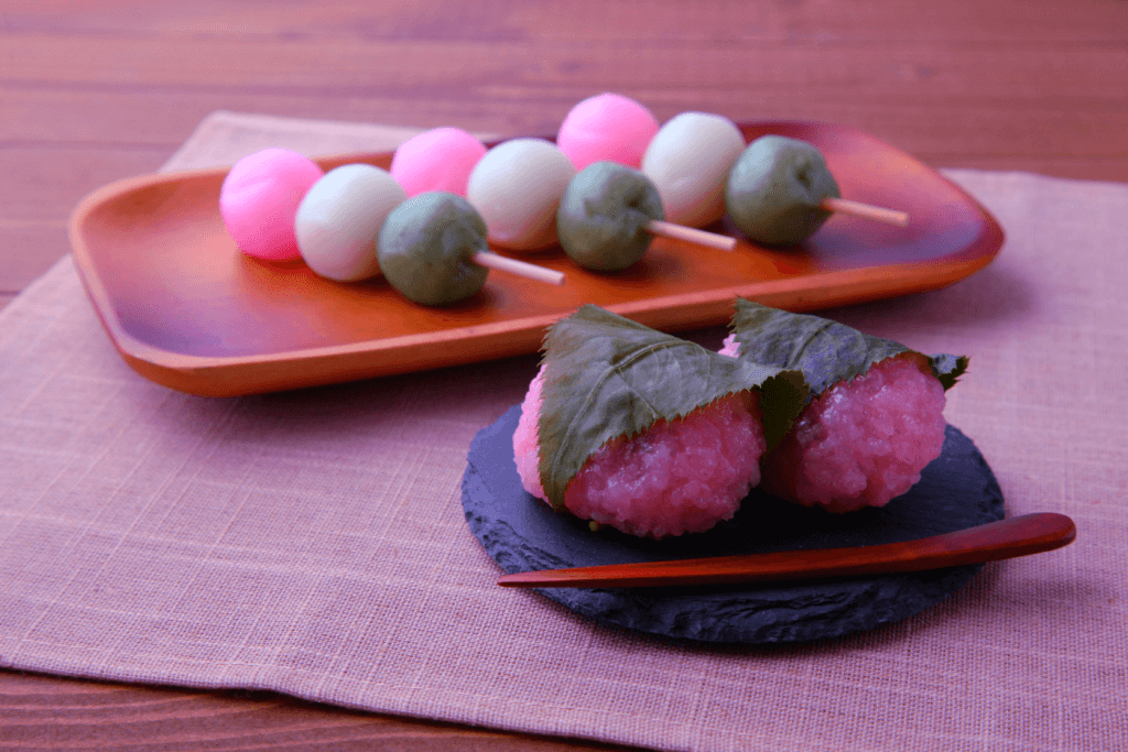 Picture of hanami dango (pink white green) and pink sakura mochi.