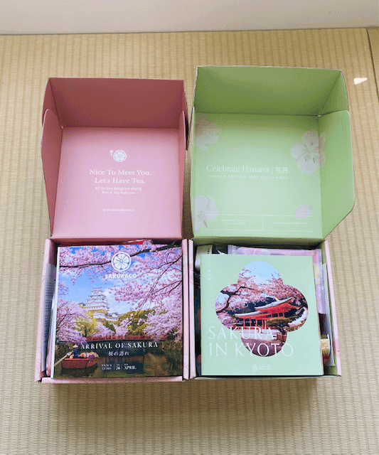 Side by side of of Sakuraco and Bokksu's boxes of sakura snacks.