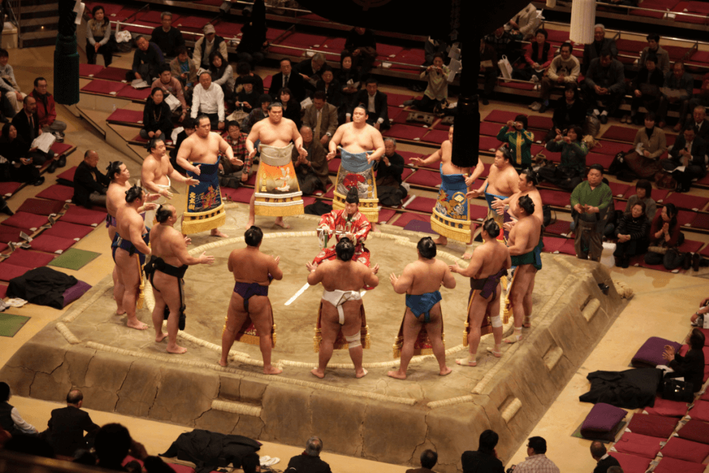 Sumo wrestlers gathering in the ring before a tournament bout.