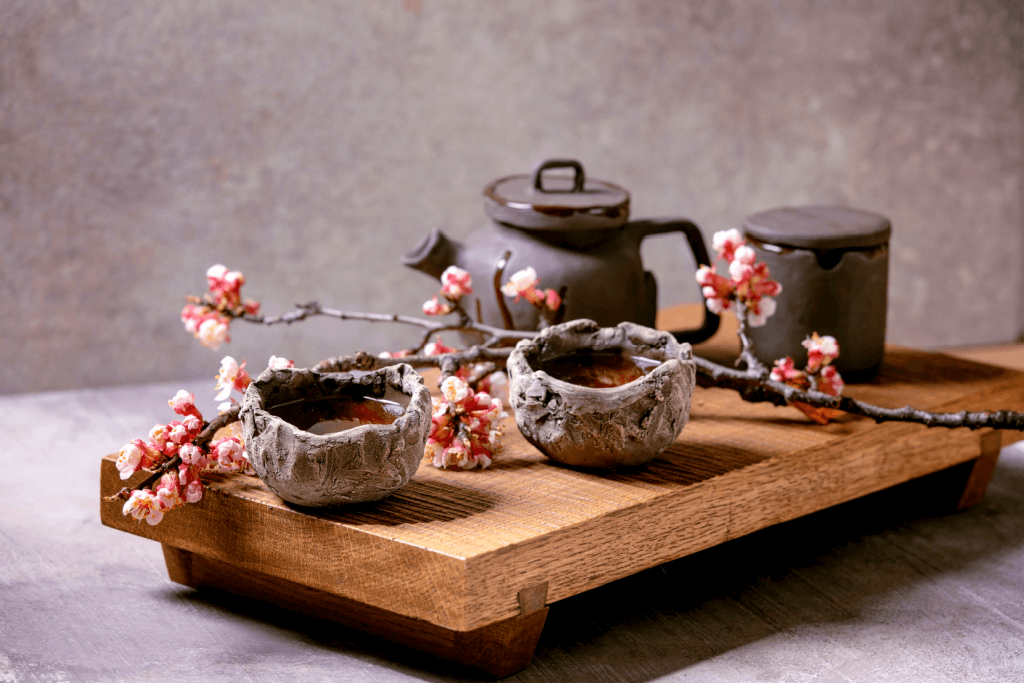 An abstract clay tea set with cherry blossoms.