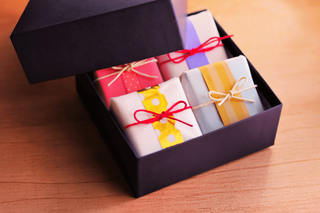 A box of small traditional Japanese gift boxes, wrapped with thin string.