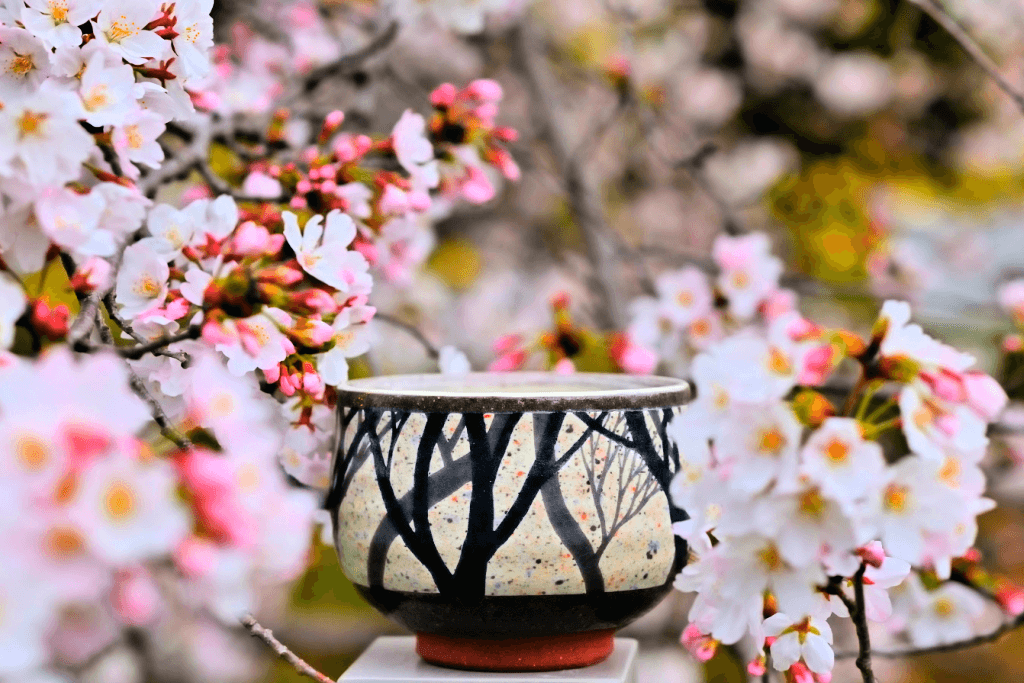 A Japanese flower vase, surrounded by sakura. This is a common addition to gift baskets for mom.
