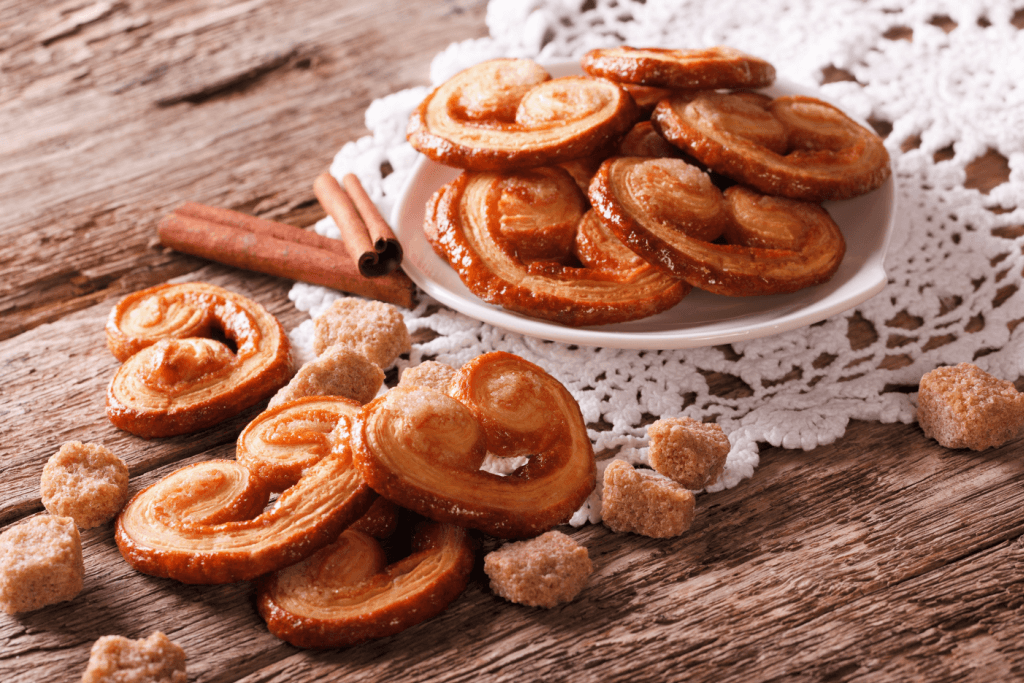 A bowl of French palmier cookies. They are heart-shaped.