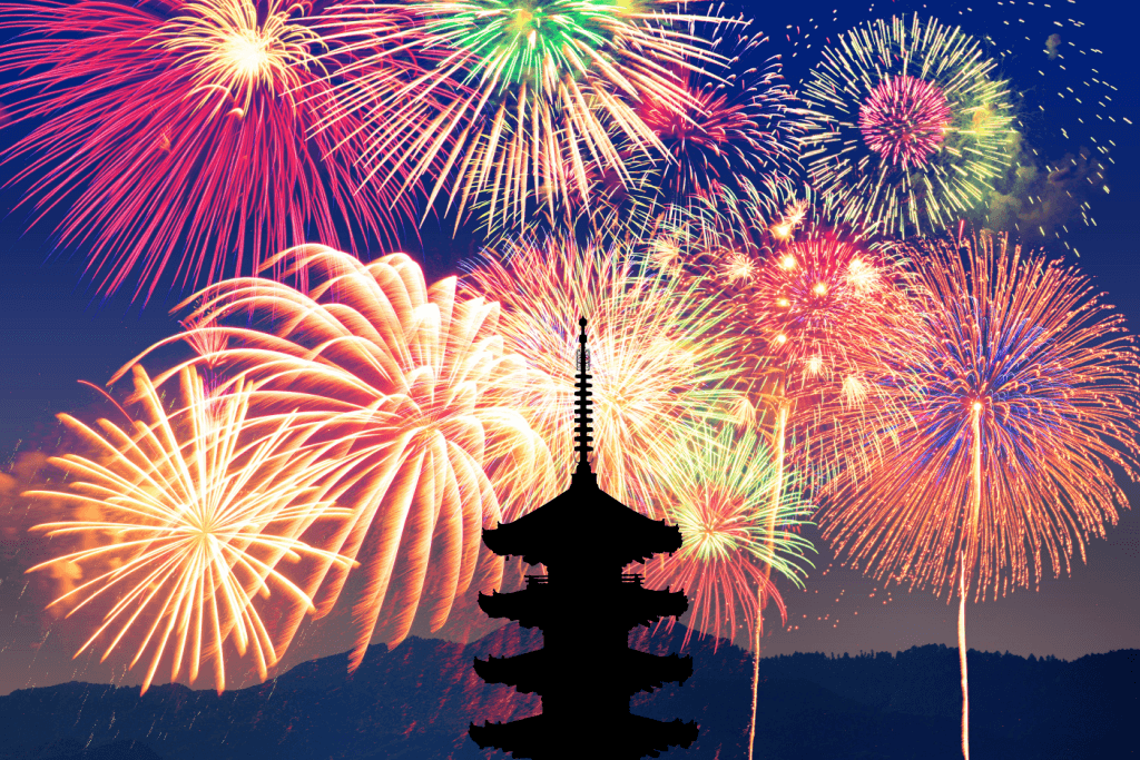 Night fireworks near a pagoda in Japan at night.