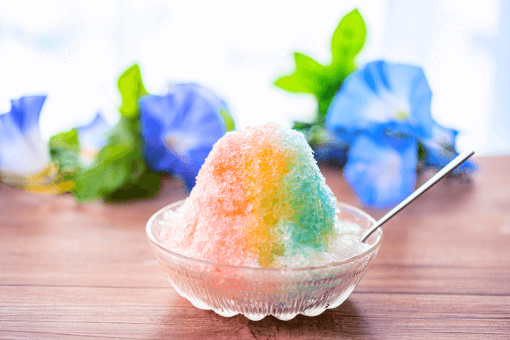 Rainbow-flavored kakigoori in a bowl o na table.