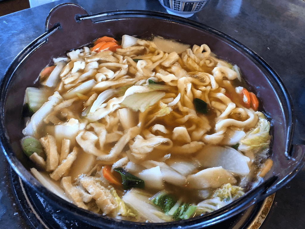 A bowl of simmered udon noodles (okkirikomi) from Gunma, Japan.