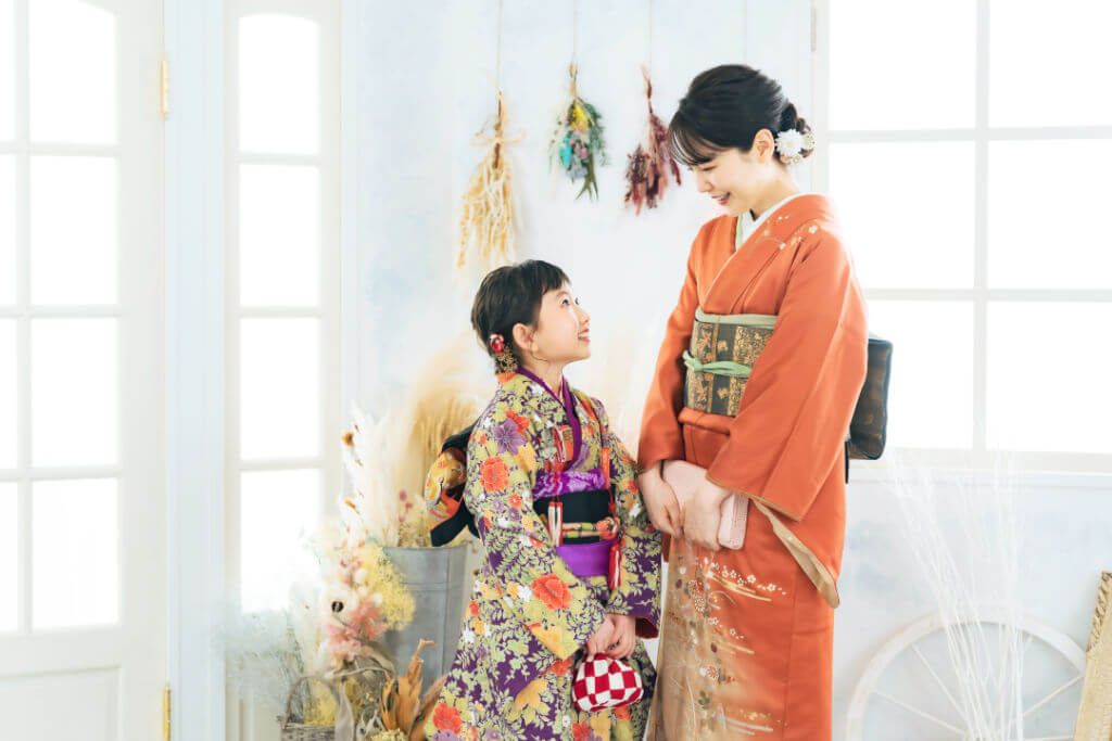 Mother and daughter in Japanese kimono. Commemorative photo in Japanese clothes.