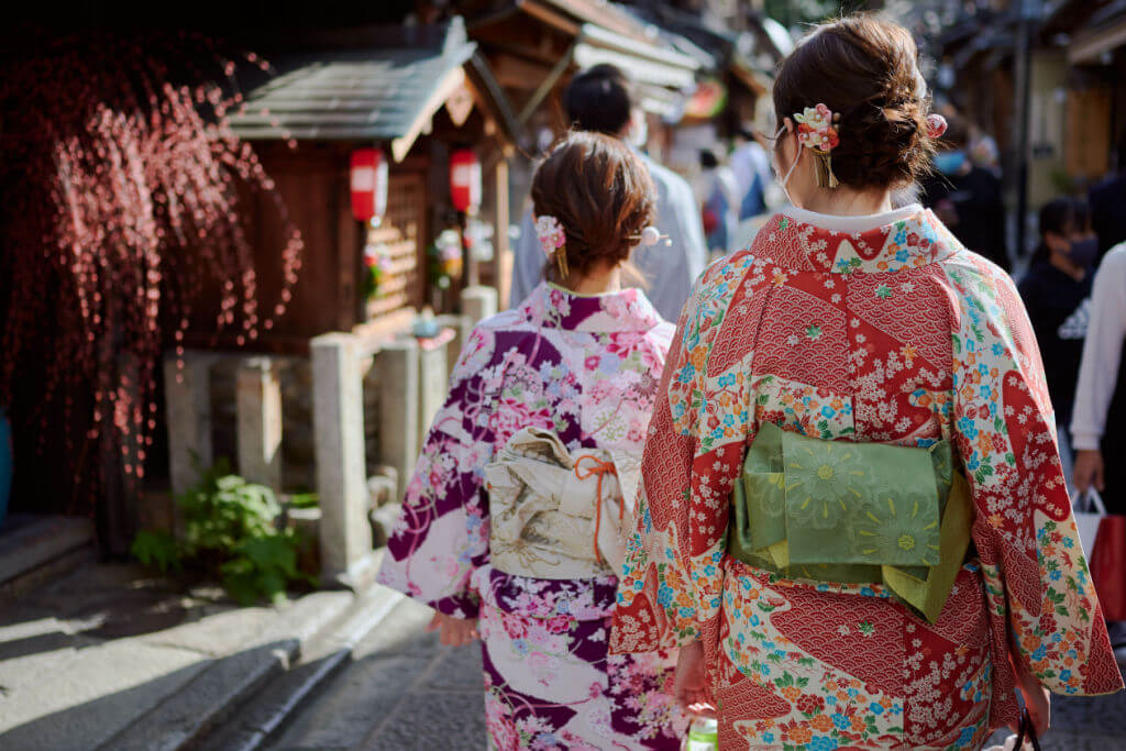 A woman in Patterned Kimono pattern Dress Walks in The Crowd