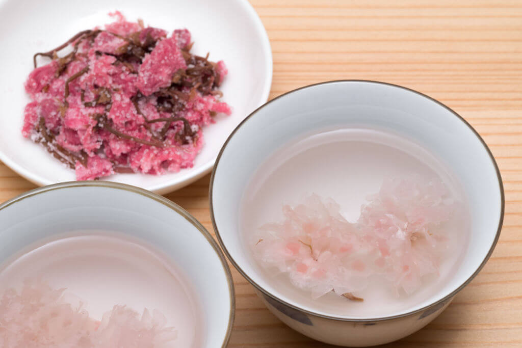 Cups of salty Japanese cherry blossom tea
