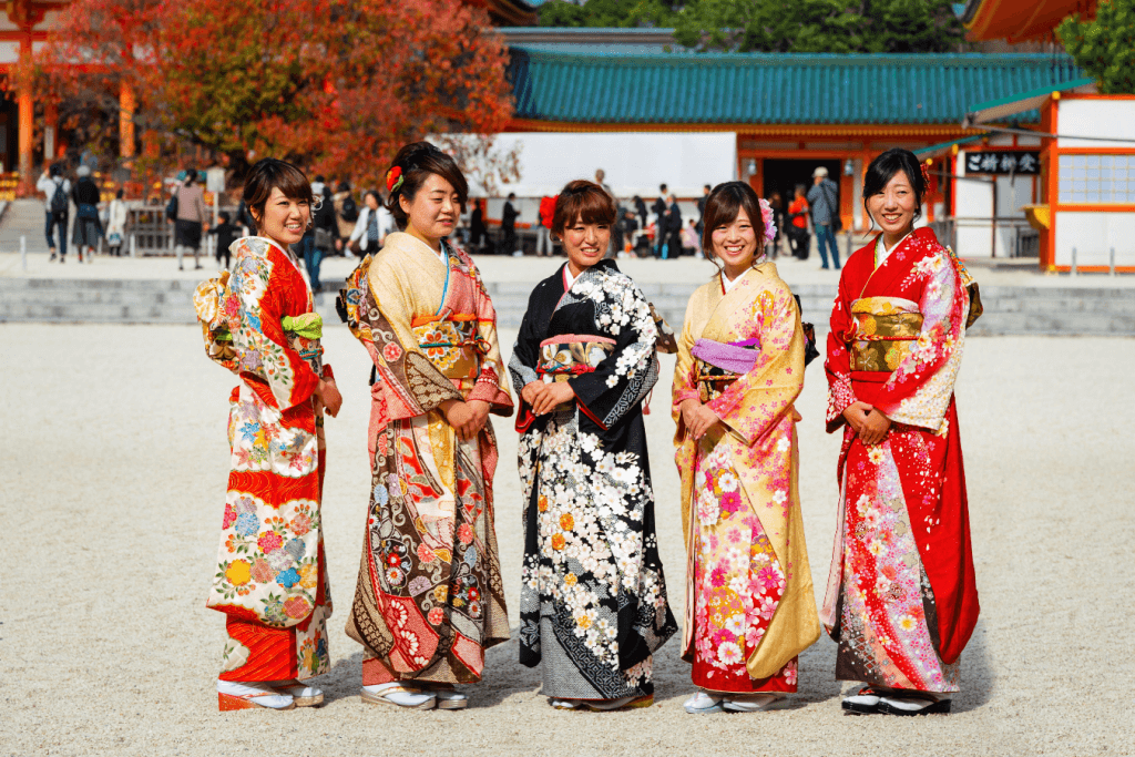 Five women wearing elaborate kimonos at Heian Shrine in Kyoto.