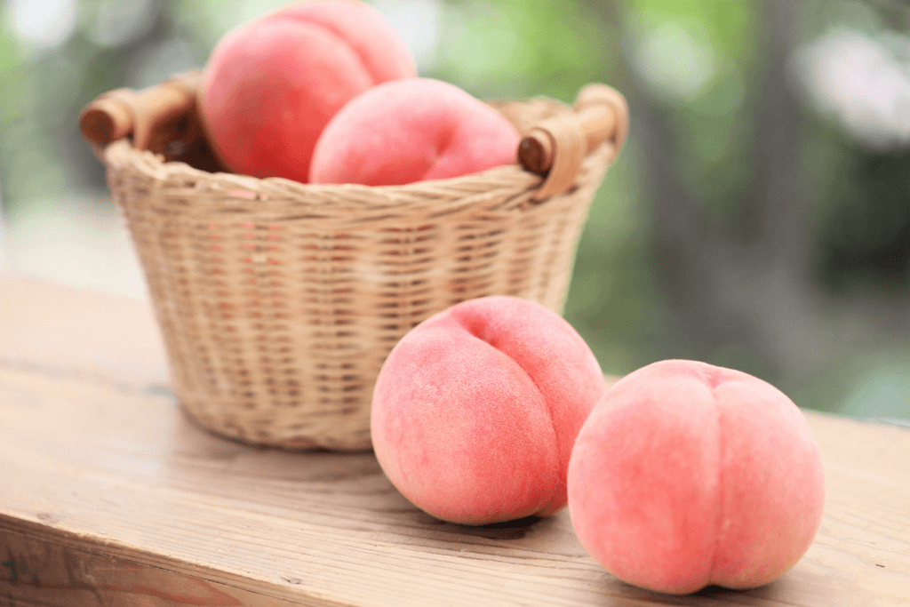 A basket of pink Japanese peaches.