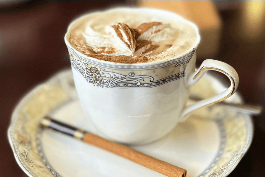 A cup of kissaten-style cinnamon coffee, serve with a cinnamon stick on the side.