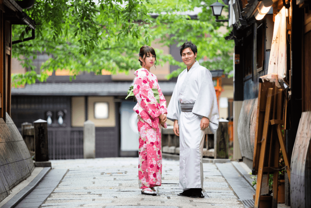 A women and a man wearing a red and white kimono respectively.