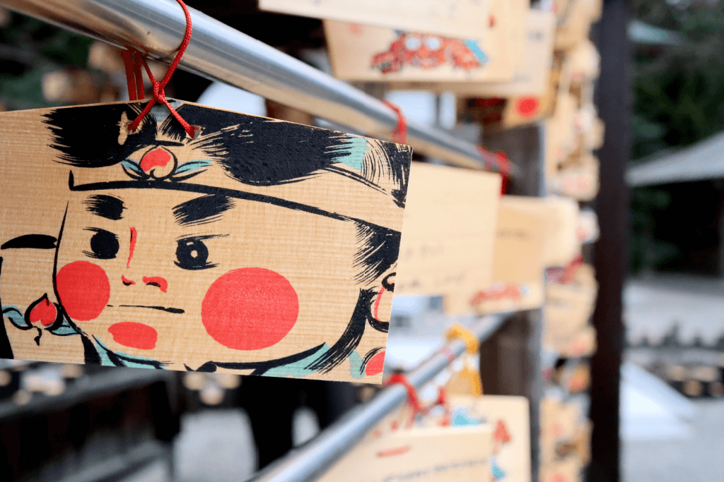 An ema (Japanese wooden board you write wishes on) with a painting of Momotaro.