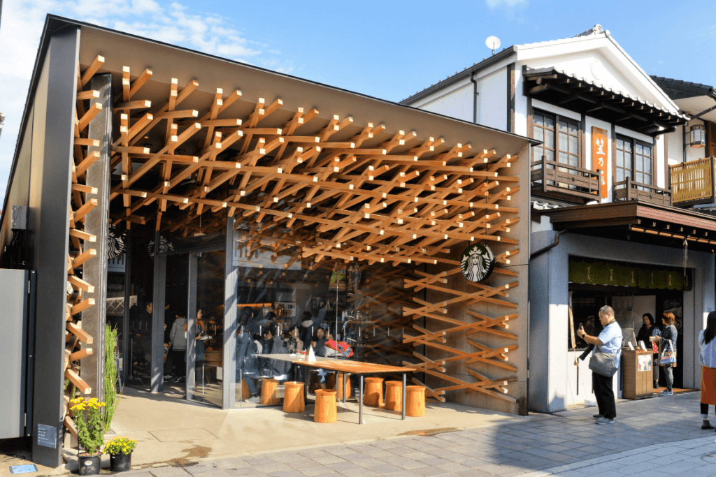 A designer's Starbucks cafe in Fukuoka. It has multiple wooden beams throughout the store.