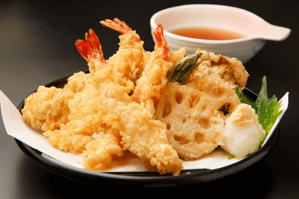A plate of tempura shrimp and vegetables.