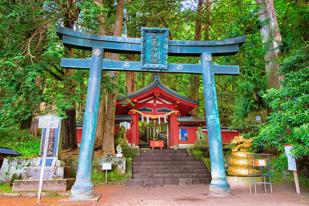 A green torii gate outside of Futarasan Shrine.