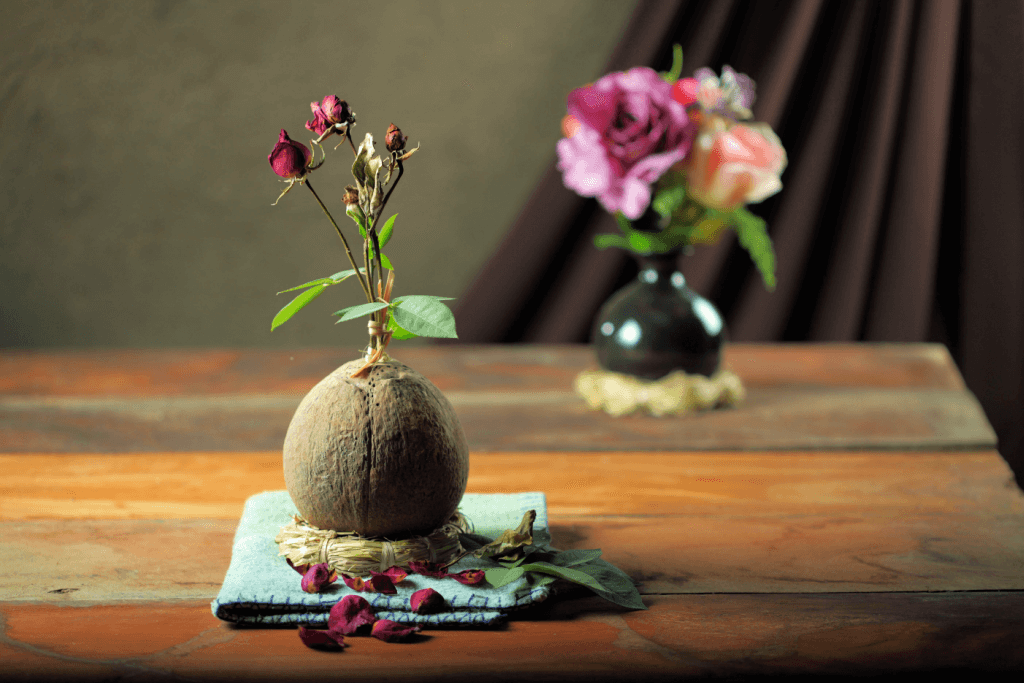 An ikebana flower arrangement in an earthen vase.