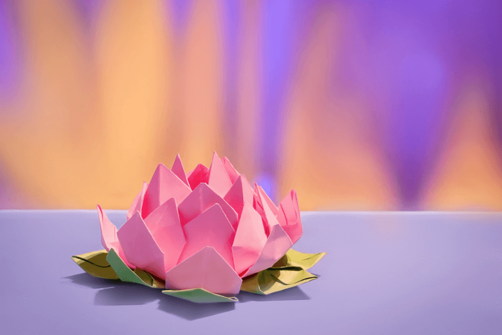 A piece of origami paper folded in a pink lotus.