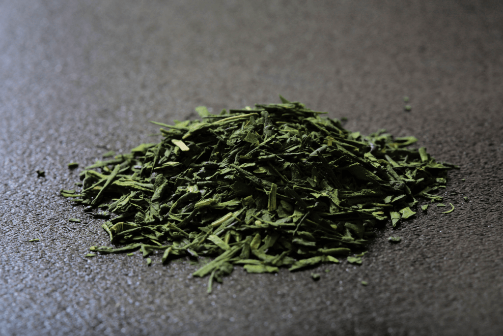 New Japanese green tea leaves on a gray background.