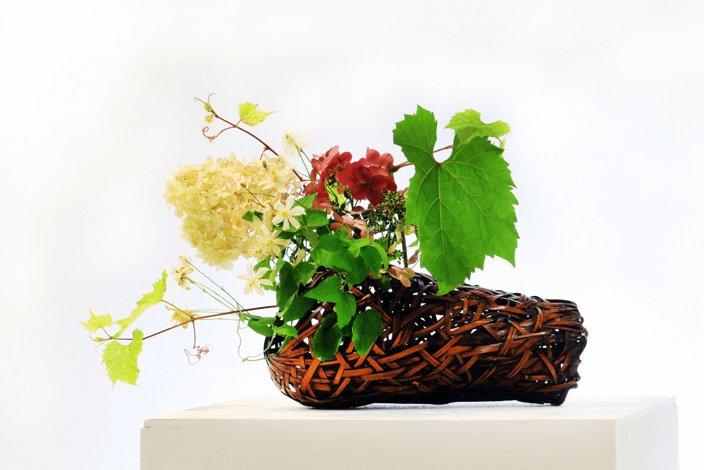 An ikebana Sogetsu flower arrangement featuring red flowers.