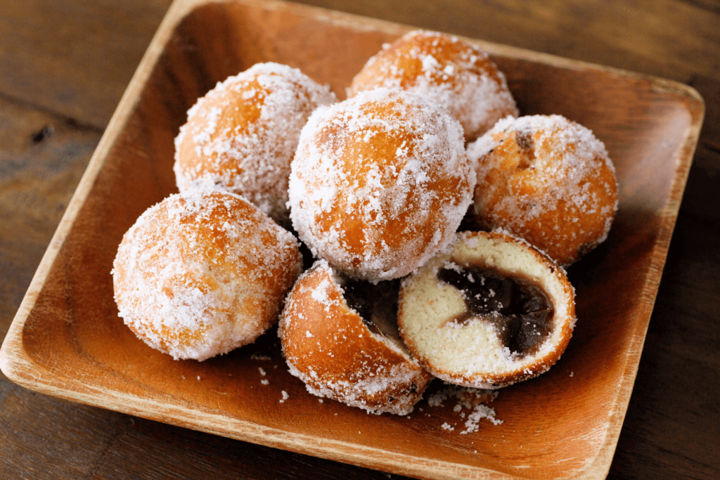 A square bowl of anko donuts.