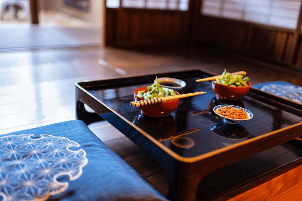 Delicate kaiseki dishes on a black lacquer table.