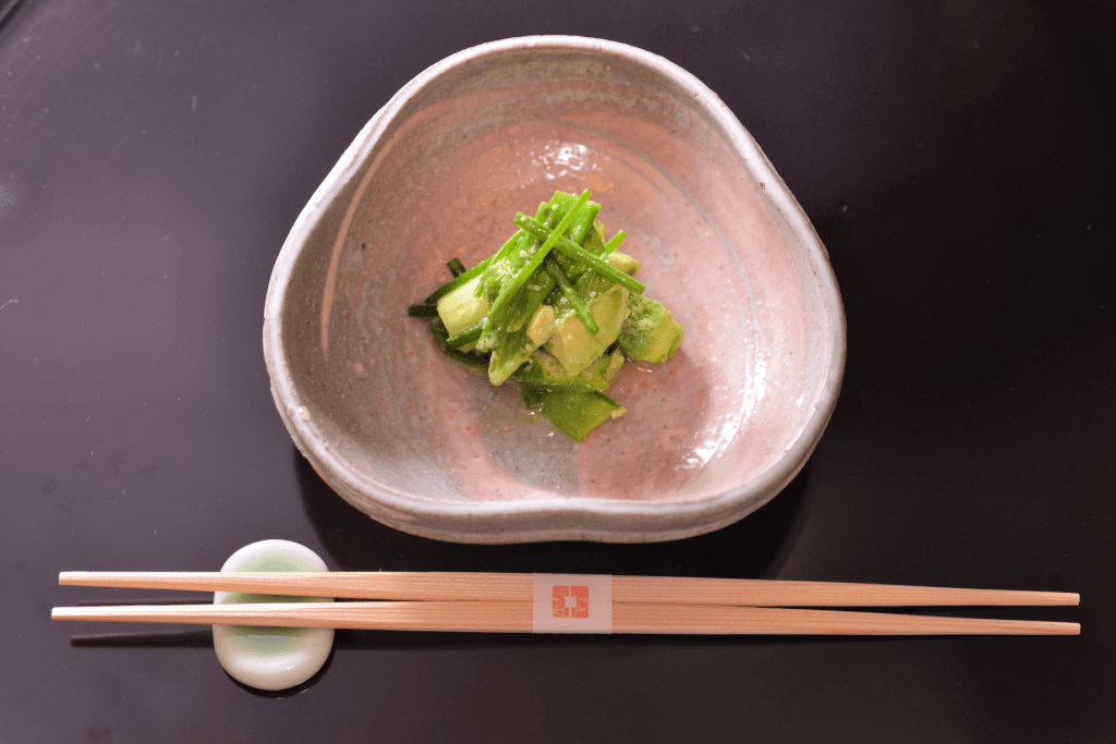 A singular kappo dish of bright green Japanese vegetables.