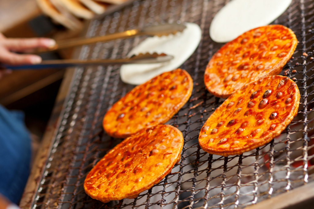 Senbei being grilled on a charcoal grill