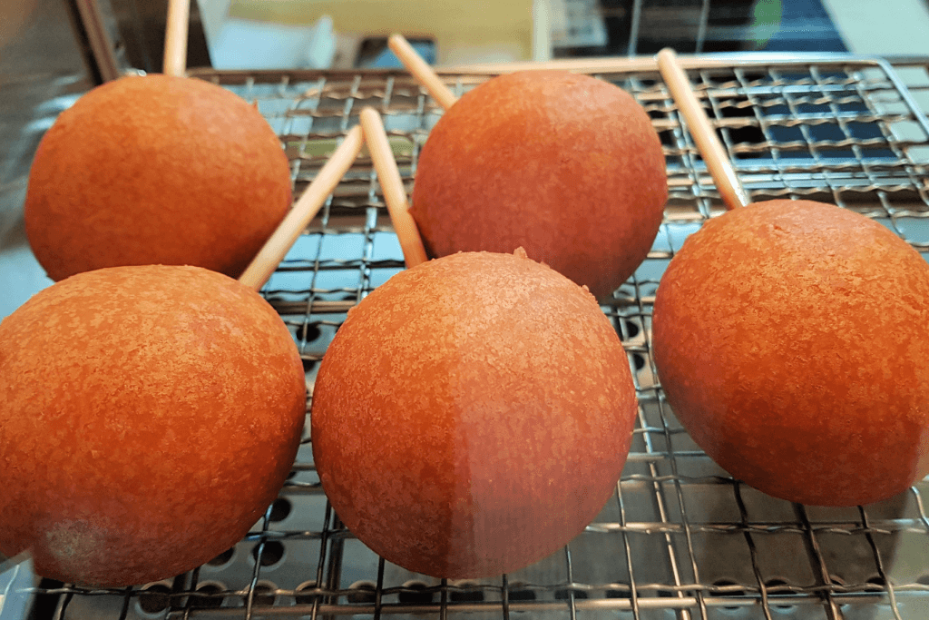 Deep-fried sweet buns, or age manju on a grill.