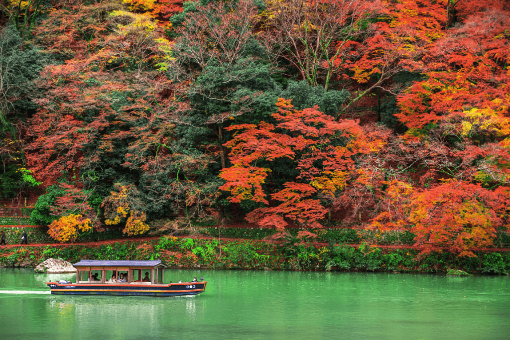 A boat on a lake in Arashiyama during the autumn.