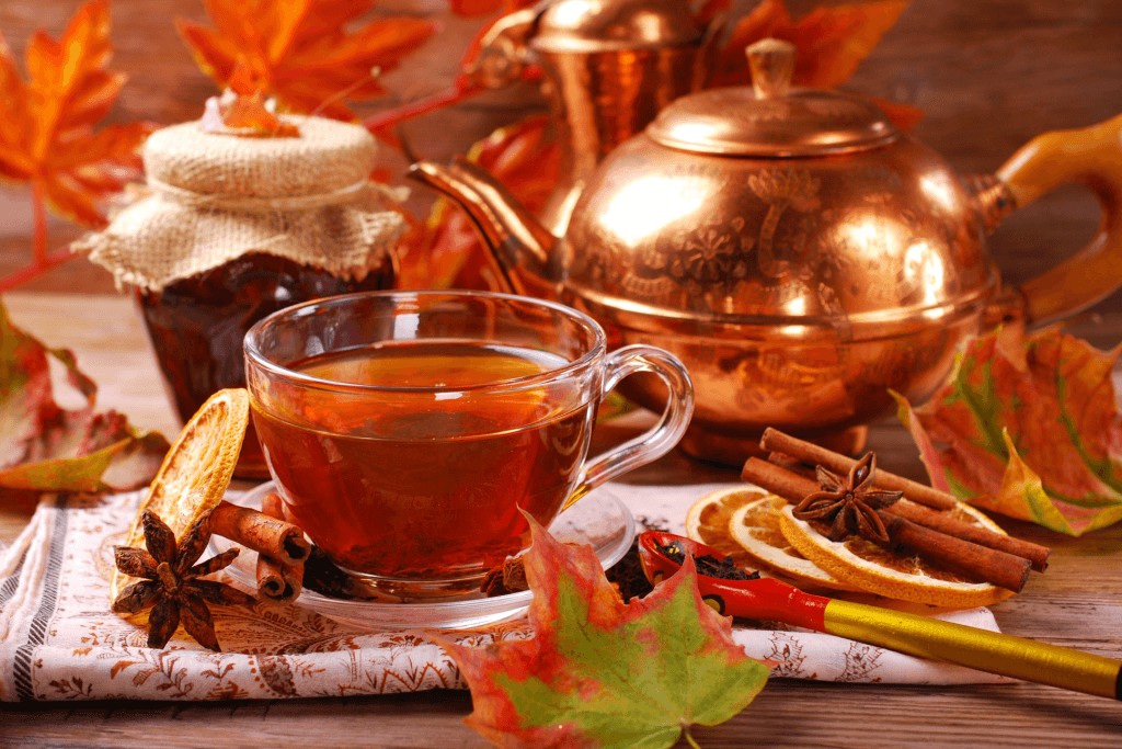 Tea in autumn surrounded by maple leaves.
