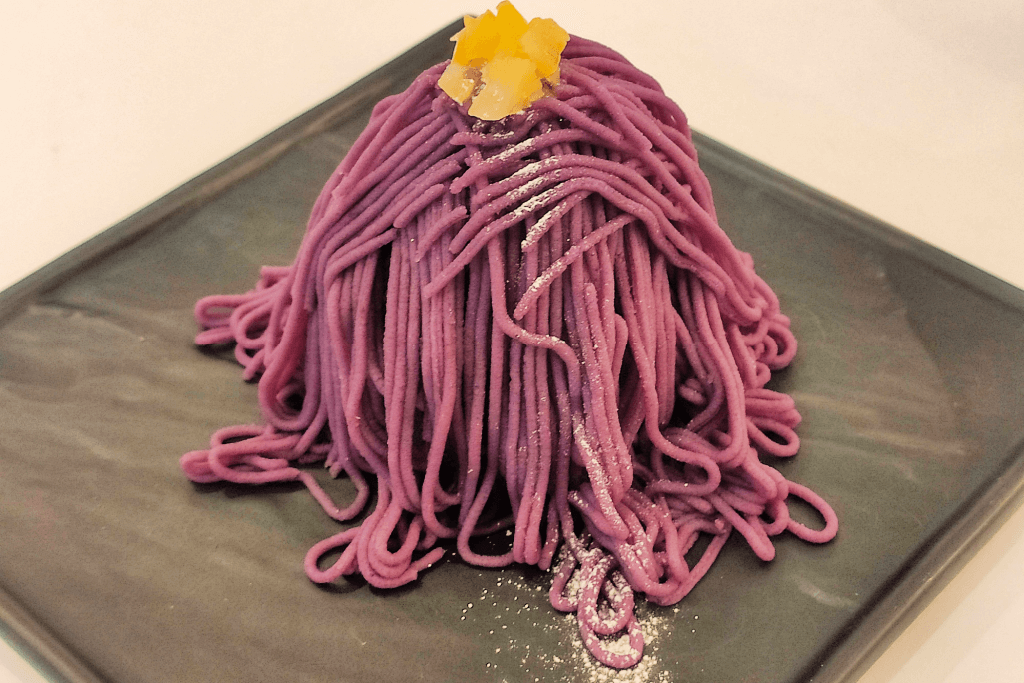 A plate of purple sweet potato Mont Blanc dessert.