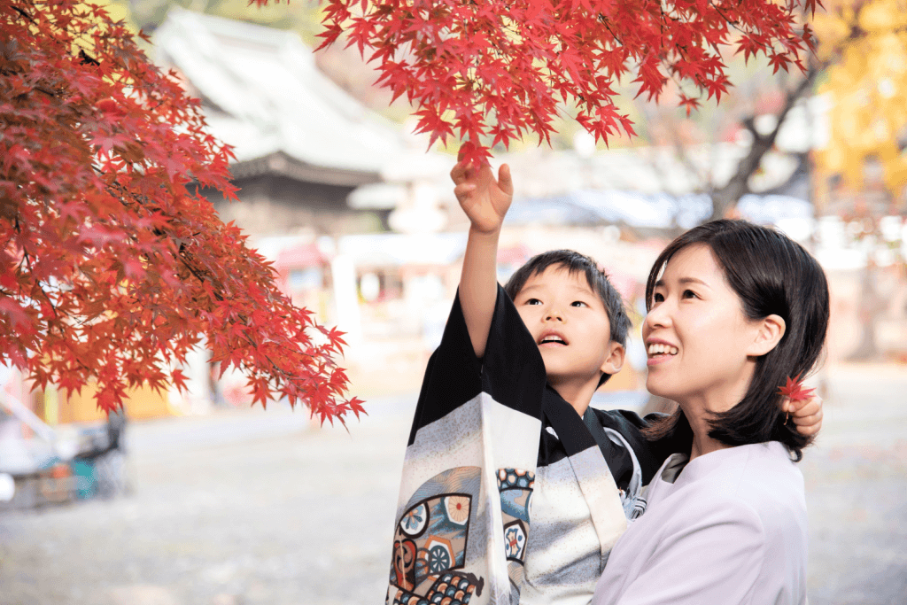 A mother and her son celebrating Shichi-Go-San, a traditional celebration during autumn in Japan.