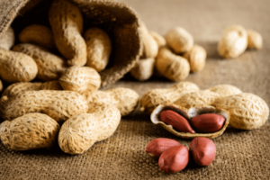 A bunch of whole peanuts in Japan on a table, spilled froma bowl.