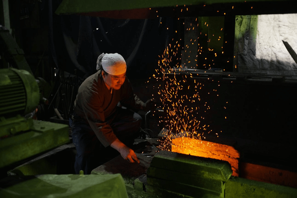 A blacksmith forging a sword at the Seki Cutlery Festival.