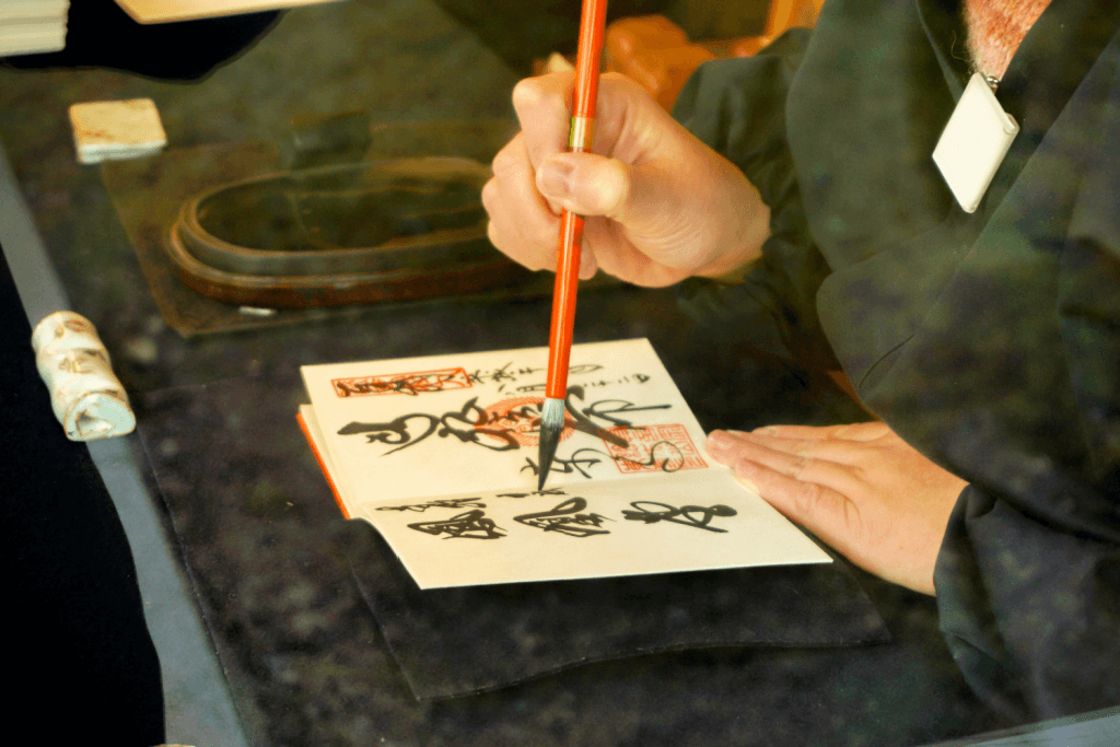 A person painting shodo, of Japanese calligraphy.