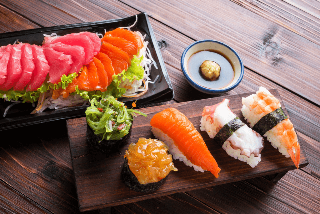 Plates of sushi and sashimi that sometimes goes with sansho pepper.