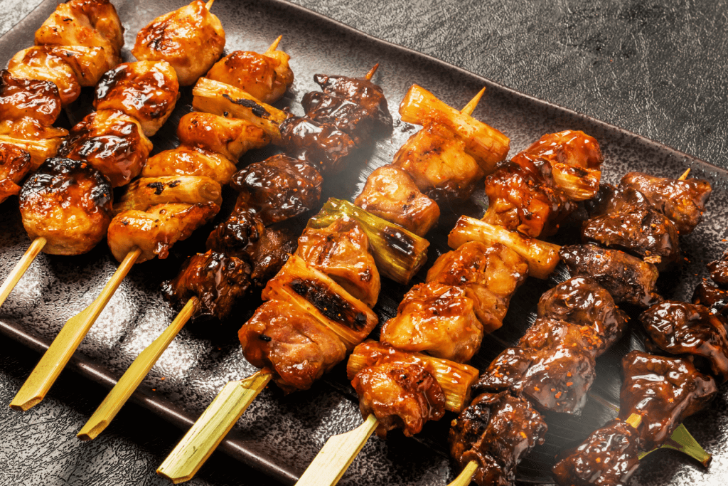 A grill with yakitori on it, a common food that goes with sansho pepper.
