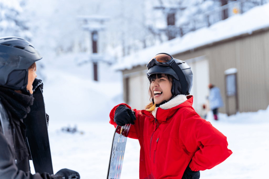 A woman laughing at one of many Japan ski resorts.