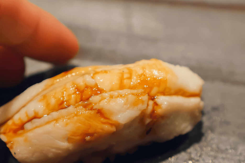 A piece of anago nigiri sushi.