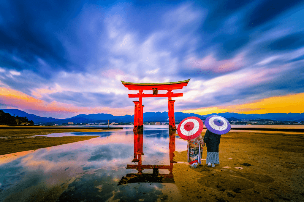 Two people standing near Itsukushima Shrine. It's one of many things to do in Hiroshima.