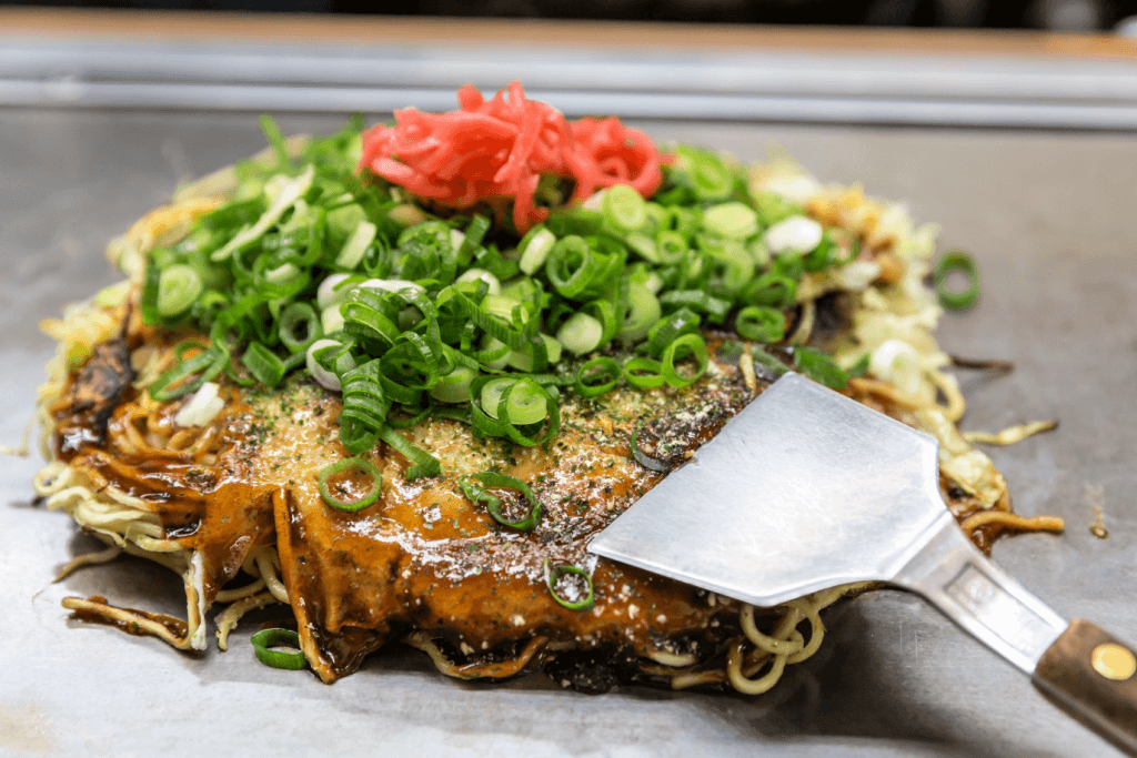 HIroshima okonomiyaki on a griddle.