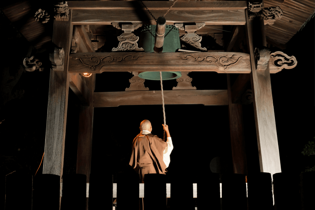 A Buddhist monk ringing the bell.