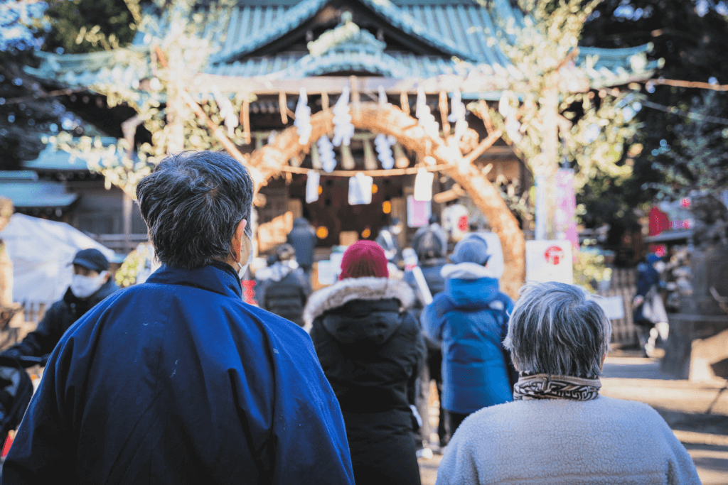 An elderly couple visiting a shrine, which is a New Year's tradition.