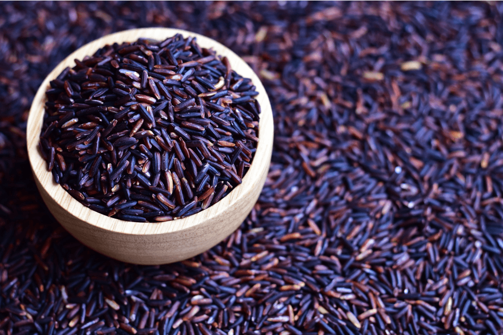 A bowl of uncooked purple rice.